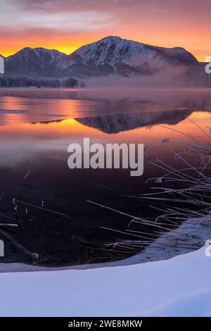 Morning redness over frozen lake in front of mountains, Lake Kochelsee, Upper Bavaria, Bavaria, Germany, Europe Stock Photo