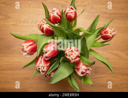tulips in vase photographed from above. Home interior decor on rustic wooden table. photo: Bo Arrhed Stock Photo