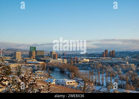 Snow covered Zurich or Zürich city. Top view panorama, rooftop POV, sunset sky, no people Stock Photo