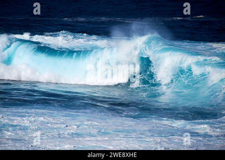 blue sea waves breaking over shallow rocky shoreline on the atlantic coast of lanzarote canary islands spain Stock Photo