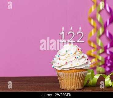 Birthday Cake With Candle Number 122 - On Pink Background. Stock Photo