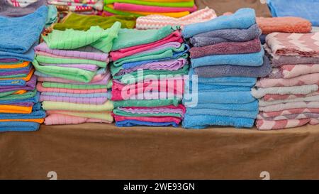 Stacks of Colourful Terry Towels Cloth at Market Stock Photo