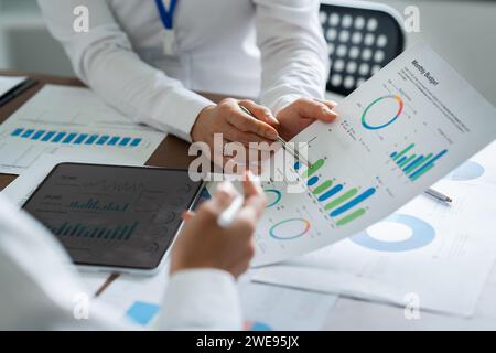 Smiling diverse employees colleagues have fun laugh cooperate brainstorm at office team meeting. Happy multiethnic businesspeople work together Stock Photo