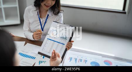 Smiling diverse employees colleagues have fun laugh cooperate brainstorm at office team meeting. Happy multiethnic businesspeople work together Stock Photo