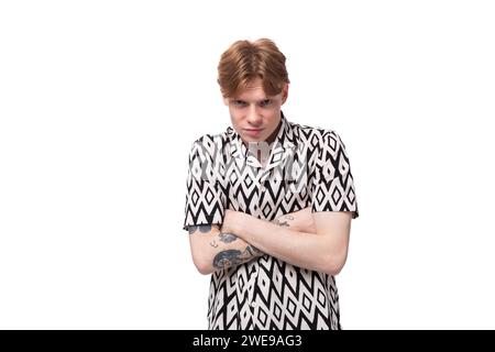 a young european guy with red hair in a summer shirt feels embarrassed and nervous Stock Photo