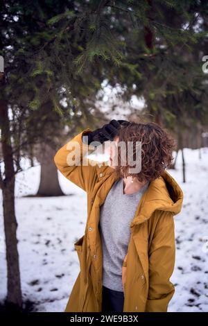 woman in yellow coat in the forest Stock Photo