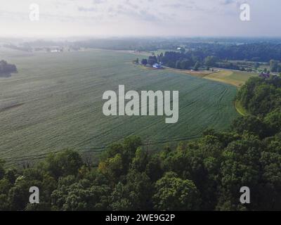 Aerial View of Serene Rural Landscape with Winding Road and Farmhouses Stock Photo