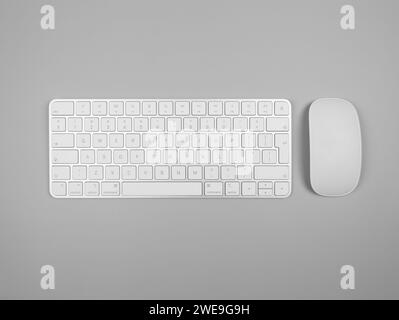 Top view of white keyboard and mouse on light grey background. Modern office flat lay, copy space. Stock Photo