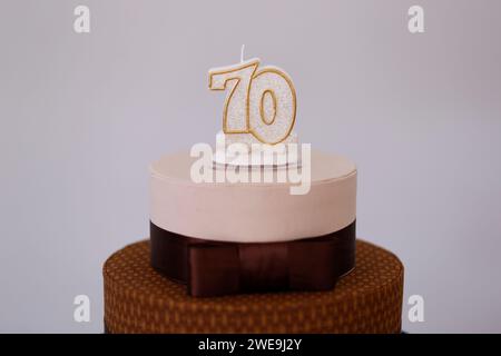 detail of the number seventy on the top of the birthday cake, 70 birthday, white cake, 70 year old birthday cake candle Stock Photo