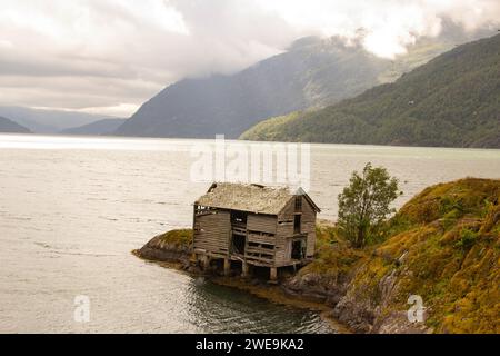 Old shelter on the mountains lake Stock Photo