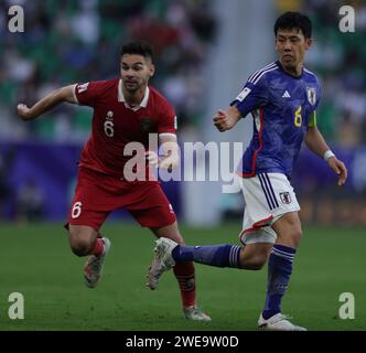 Doha, Qatar. 24th Jan, 2024. DOHA, QATAR - JANUARY 24: Sandy Walsh of Indonesia and KV Mechelen and Wataru Endo of Japan and Liverpool FC in action during the AFC Asian Cup Group D match between Japan and Indonesia at Al Thumama Stadium on January 24, 2024 in Doha, Qatar. Credit: Sebo47/Alamy Live News Stock Photo