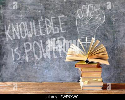 Knowledge is power,books and blackboard with drawing of a lightbulb ...
