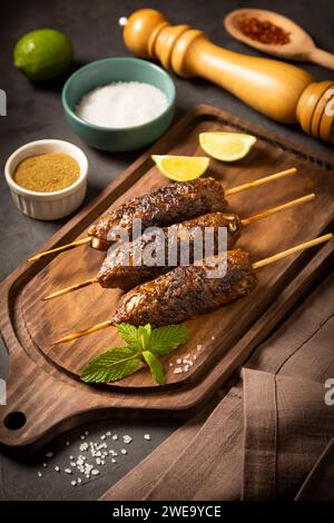 Beef kafta on the wooden board. Kafta, Traditional Arabic cuisine. Stock Photo