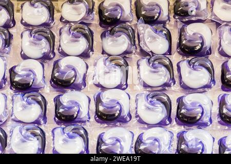 Laundry pods are film-coated packets of concentrated liquid or powder detergent designed to dissolve when they come into contact with the water. Stock Photo