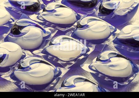 Laundry pods are film-coated packets of concentrated liquid or powder detergent designed to dissolve when they come into contact with the water. Stock Photo