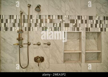 Luxurious Marble Shower with Brass Fixtures and Mosaic Accents Stock Photo