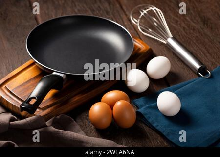 White and brown chicken eggs go up on the table. Stock Photo