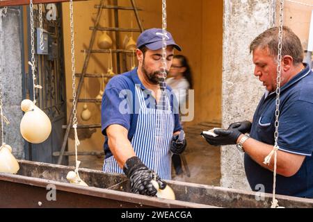 Vendors prepare caciocavallo cheese, called Impiccato, at the festival, autumn in Ospedaletto d'Alpinolo near Avellino, Italy Stock Photo