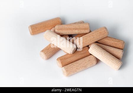 Pile of wooden dowels on the white background Stock Photo