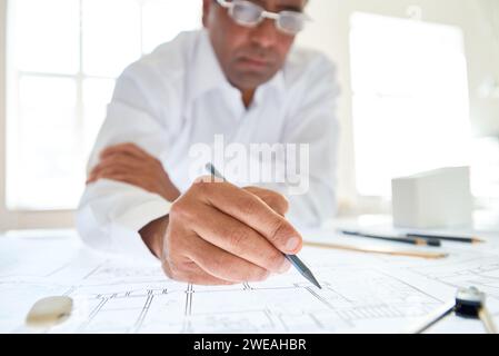 Close up of unrecognizable male architect drawing plans with focus on hand holding pencil, copy space Stock Photo
