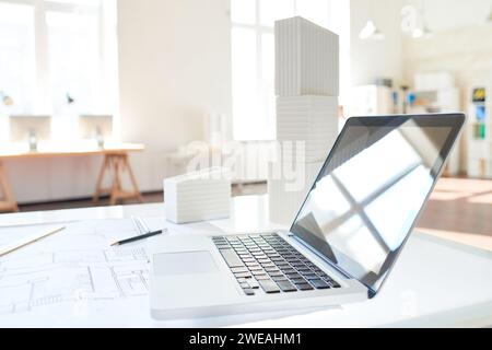 Side view background image of open laptop on drawing table in architects office, copy space Stock Photo