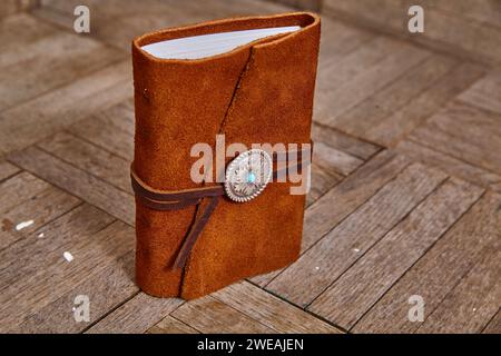 Handcrafted Leather Journal with Turquoise Clasp on Wooden Background Stock Photo