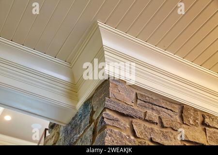 Elegant Crown Molding and Textured Stone Wall Interior Detail Stock Photo
