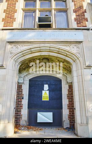 Boarded-up Asbestos Warning on Abandoned Hospital Entrance Stock Photo