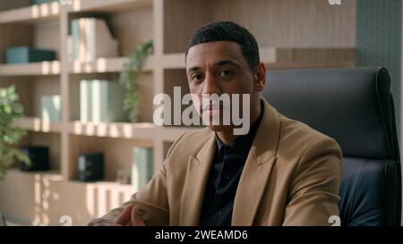 Portrait of serious African American man entrepreneur commercial business work at office male businessman CEO chief working with laptop computer Stock Photo