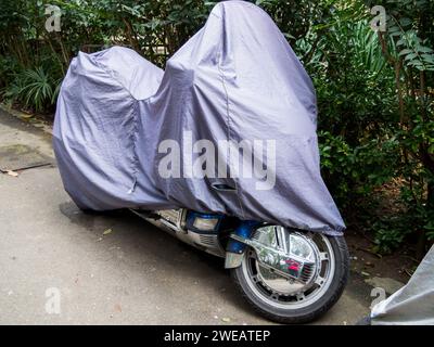 Sochi, Russia - February 12, 2023: The motorcycle stands at the side of the road under a protective awning Stock Photo