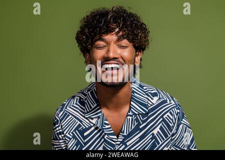 Closeup photo of young funny guy laughing mexican student in shirt enjoying comic joke at stand up show isolated on khaki color background Stock Photo
