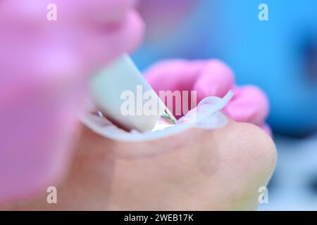 Close up of orthodontist scaning patient with dental intraoral 3d  scanner. Modern dental clinic with equipment. Prosthodontics and stomatology concep Stock Photo