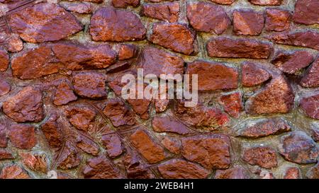 Close-up view of rough weathered stone wall texture, full frame background Stock Photo