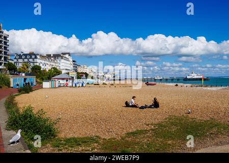 Shingle beach, promenade and view of Eastbourne Pier in Eastbourne, East Sussex, a resort town on England’s south-east coast, looking east Stock Photo