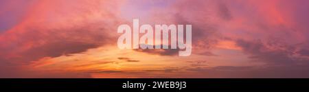 Romantic sky with clouds at sunset. Dramatic cloudscape panorama. Stock Photo