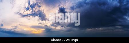 Dramatic sunset sky with dark clouds. Beautiful cloudscape at dusk. Stock Photo