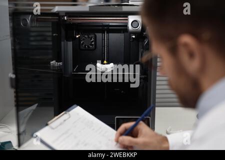 Technician Documenting Printed 3D Dental Prosthesis Stock Photo