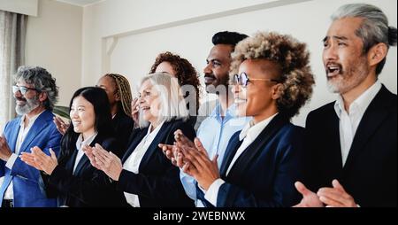 Business group of people celebrate inside bank office. Happy multiracial workers during conference meeting Stock Photo