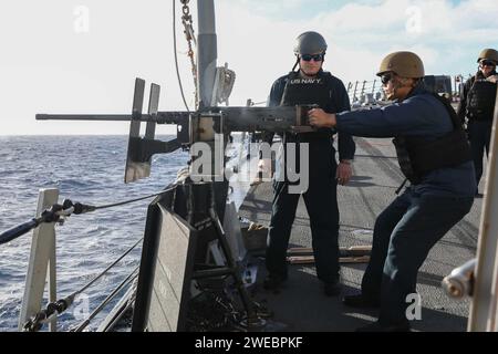 Sailors aboard the Arleigh Burke-class guided-missile destroyer USS Thomas Hudner (DDG 116) conduct crew-served weapons training while underway Stock Photo