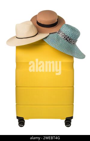 Travel yellow suitcase with hats hanging on top isolated on white background. Travel shopping or travel choice concept Stock Photo