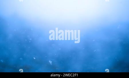 Blue snowfall background effect. Abstract dynamic energy background. Shallow depth of field with soft focus. Stock Photo