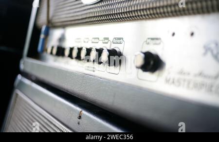 Close up electric guitar amplifier. Master regulator knob, volume level. Stock Photo