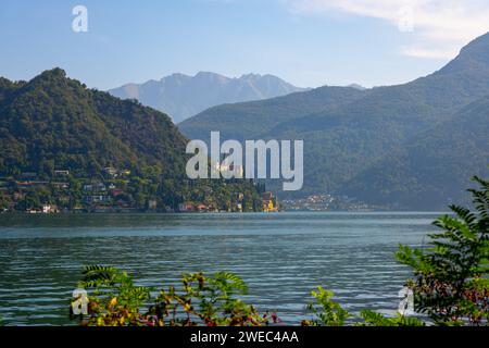 Church Santa Maria del Sasso with Trees Branches on the Mountain Side and Lake Lugano in Morcote, Ticino, Switzerland. Stock Photo