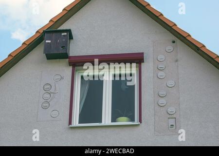nesting aids for swifts and bats on a house facade under the roof, Germany Stock Photo