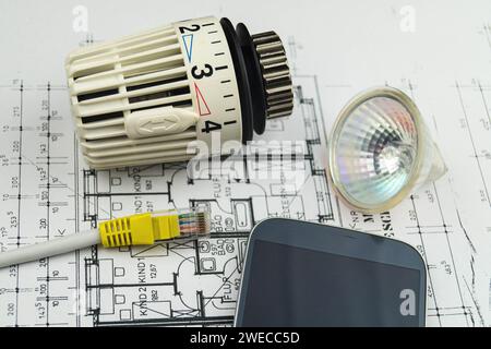 Smartphone, network plug, reflector lamp and radiator thermostat, symbolic image for Smart Home Stock Photo
