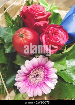 colorful bouquet with roses, gerberas and apple Stock Photo