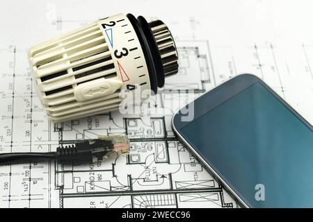 Smartphone, network plug and radiator thermostat, symbolic image for Smart Home Stock Photo