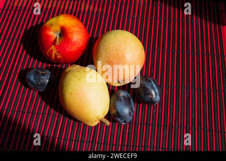 There are apples, pears and plums on the table. Fresh fruit close up. Stock Photo