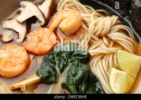 Delicious ramen with shrimps and mushrooms in bowl, closeup. Noodle soup Stock Photo