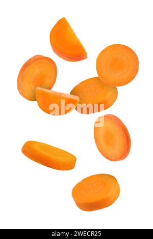 Fresh carrot slices falling on white background Stock Photo